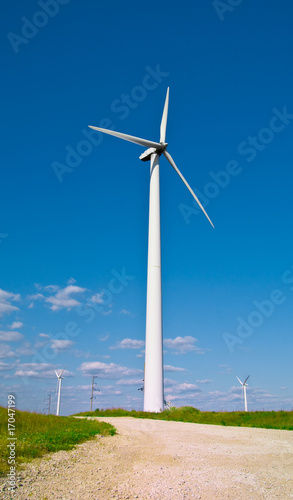 Wind power station - wind turbine against the blue sky