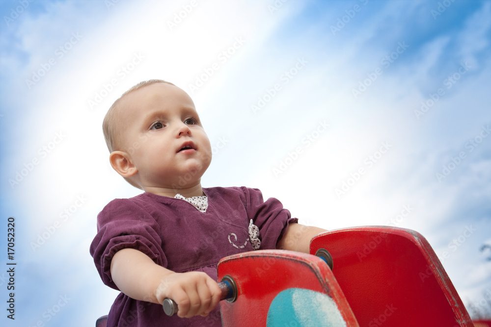 Fototapeta premium two year old girl sitting on swing