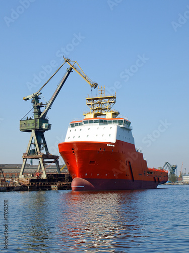 Red tug in shipyard