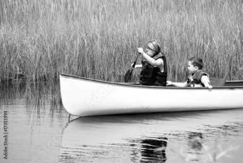 children paddling through wetlands
