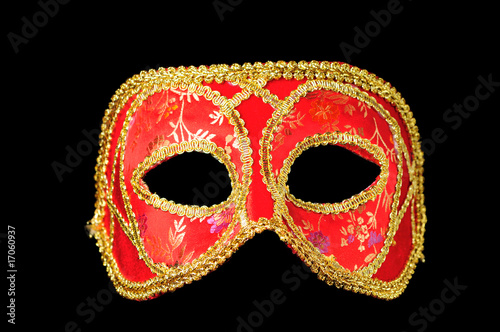 Venetian mask red with gold isolated on black