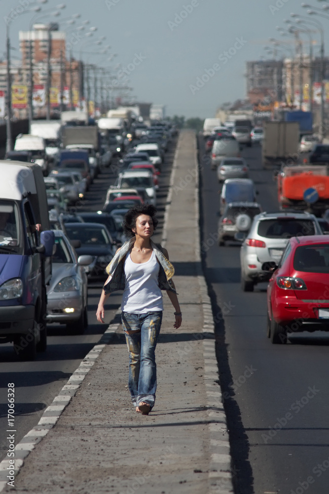 girl goes on highway middle in city