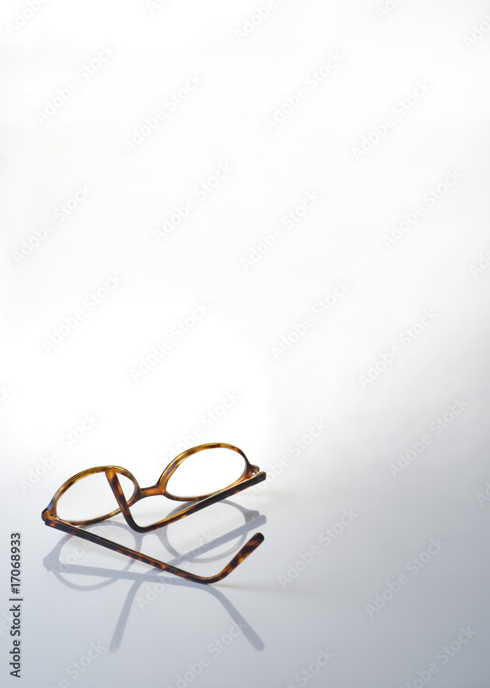 Brown glasses on light gray to white