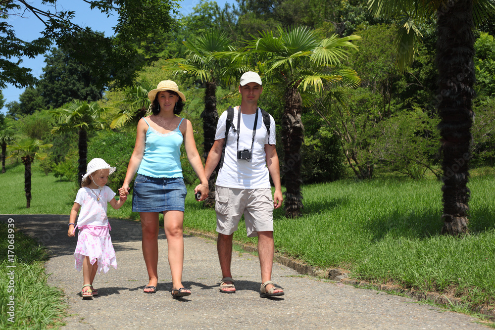 family walk on road in Sochi arboretum