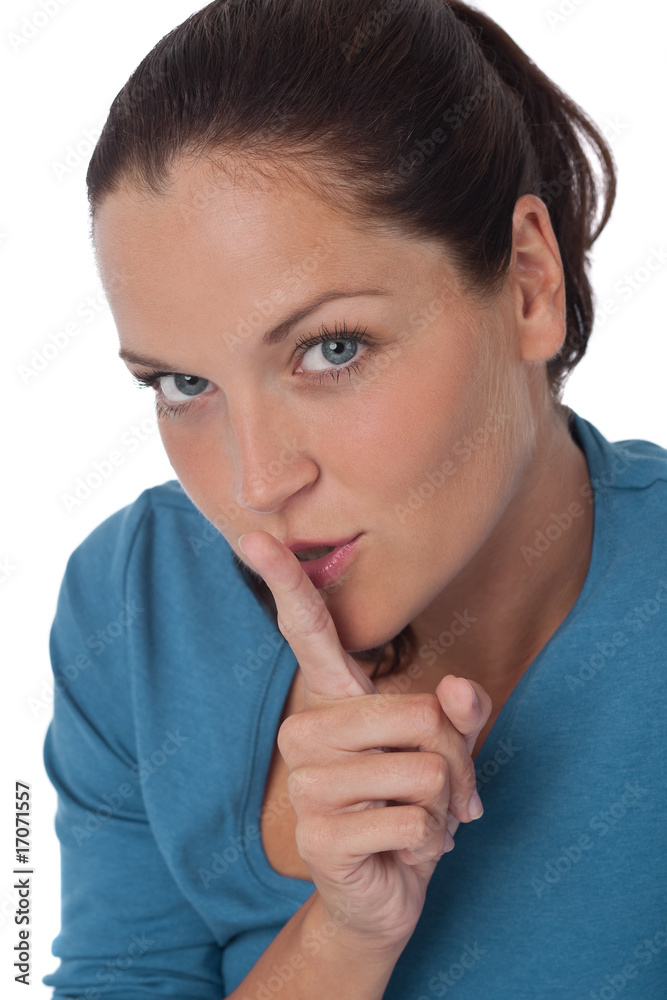 Beautiful young woman with finger on lips Beautiful young woman with finger on lips