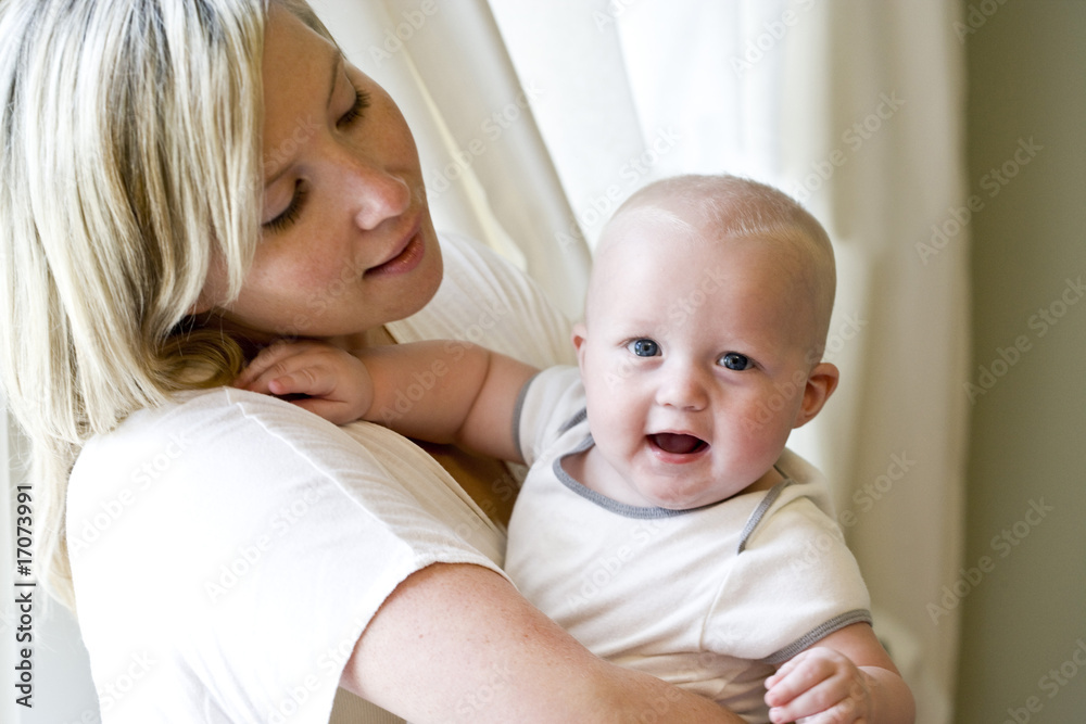 Mother holding happy seven month old baby Mother holding happy seven month old baby