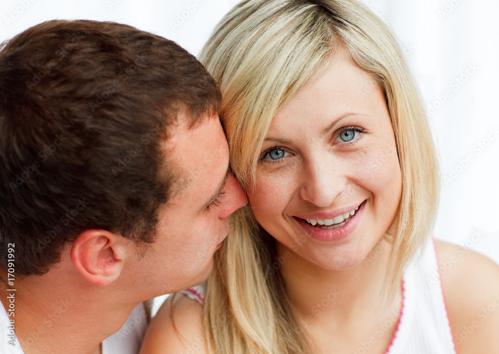 Man whispering a woman something funny Man whispering a woman something funny