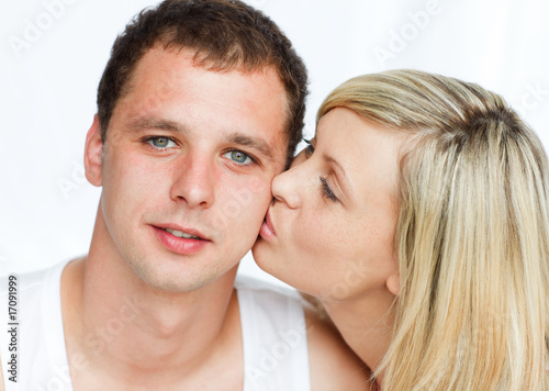 Woman kissing a handsome man