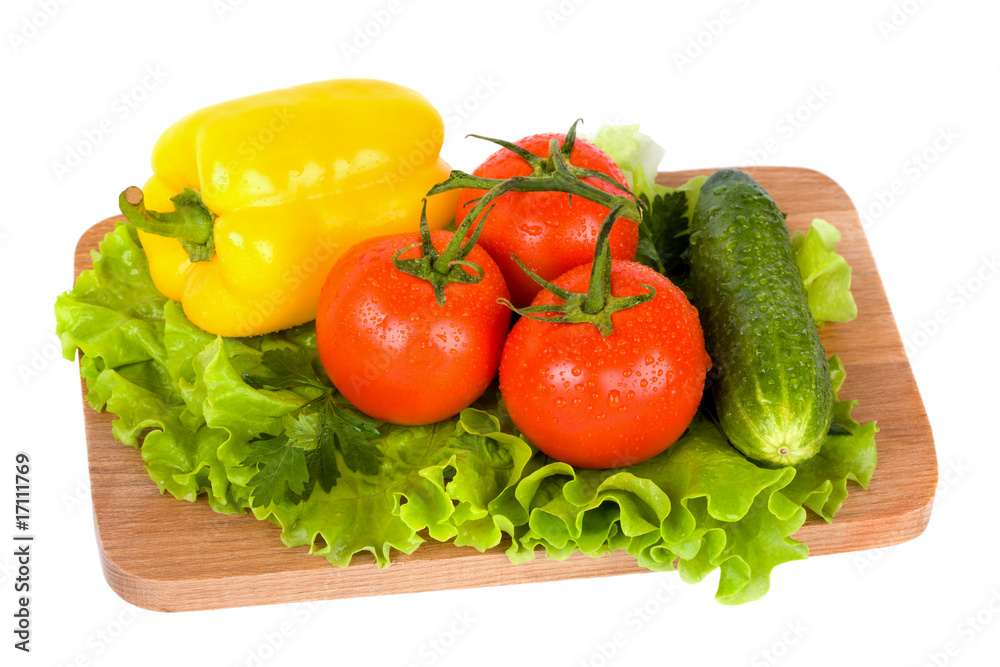 Fresh colorful vegetables on wooden board isolated on white Fresh colorful vegetables on wooden board isolated on white