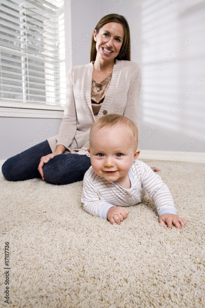 Mother with baby learning to crawl Mother with baby learning to crawl