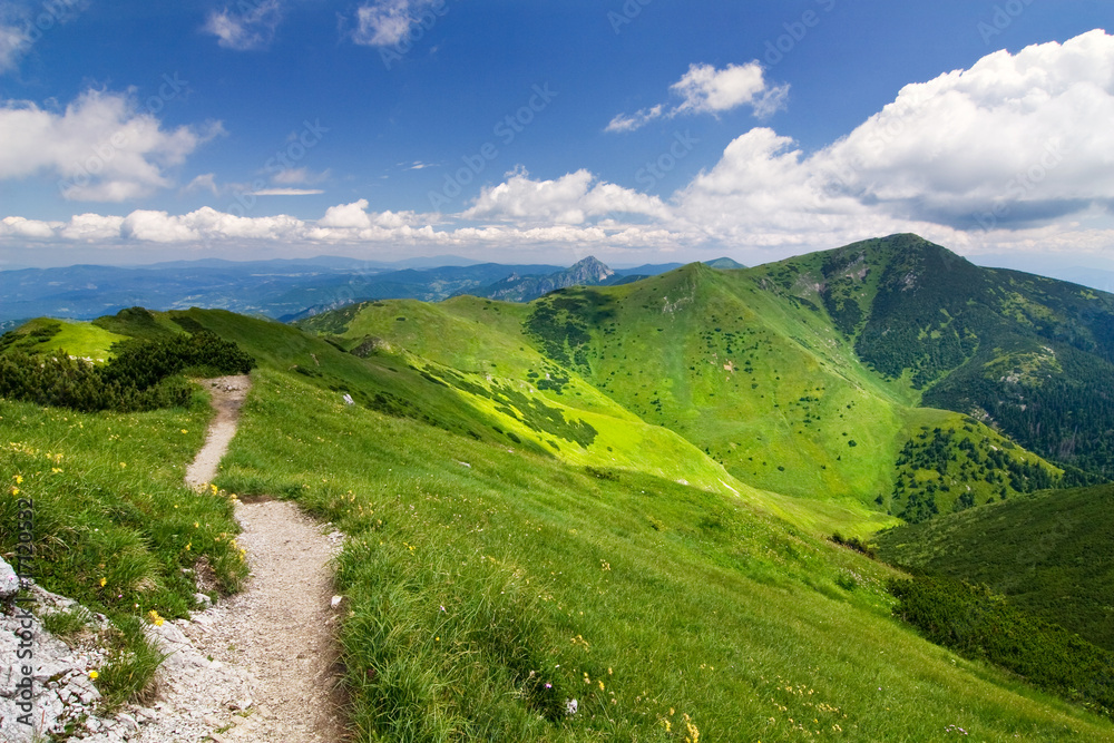 Fototapeta premium Mountain-ridge and blue sky with white clouds