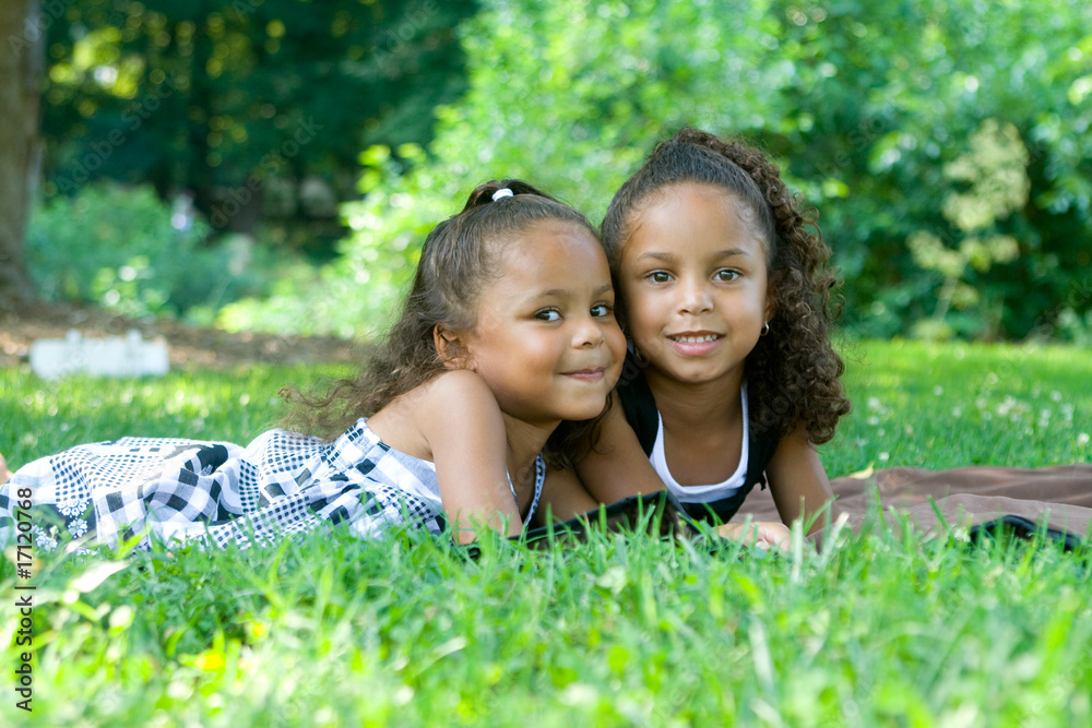 Two beautiful mixed race sisters enjoying the park Two beautiful mixed race sisters enjoying the park