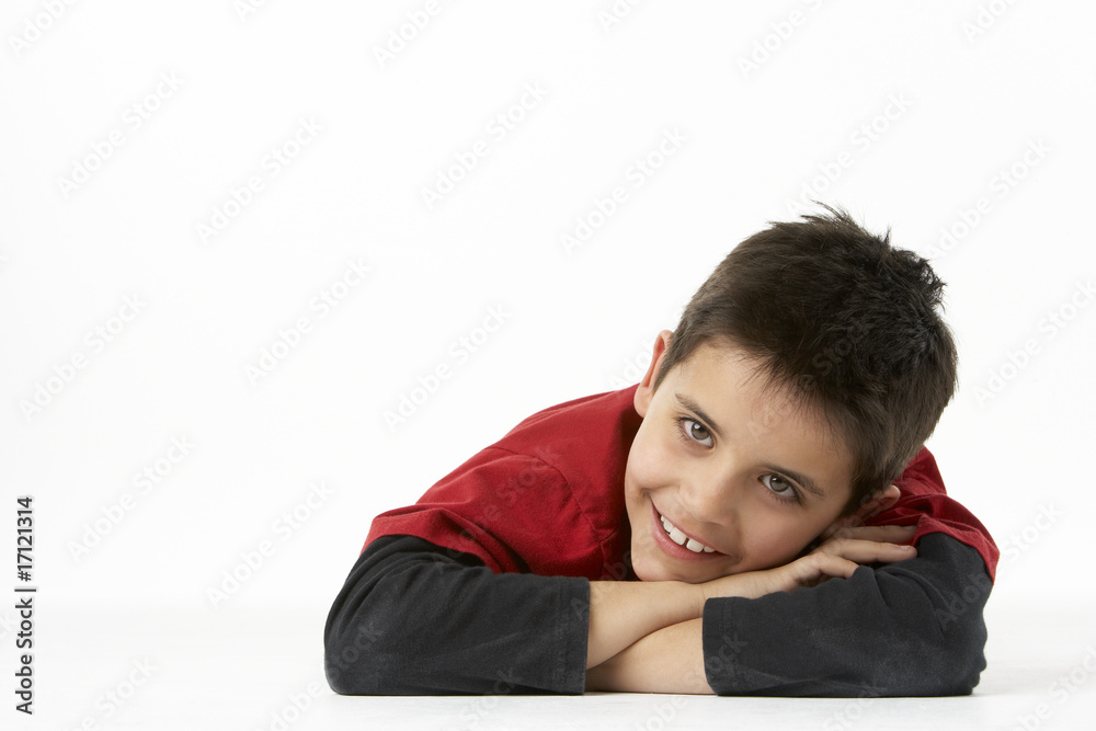 Young Boy Lying On Stomach In Studio Young Boy Lying On Stomach In Studio