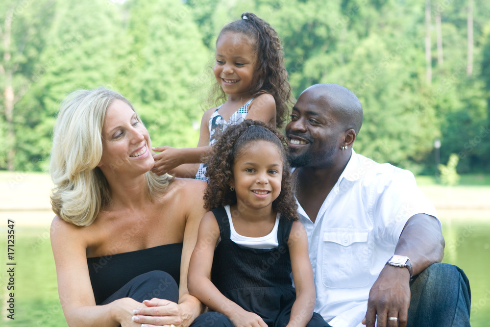 A loving mixed race family enjoying the park