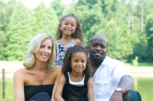 A loving mixed race family enjoying the park