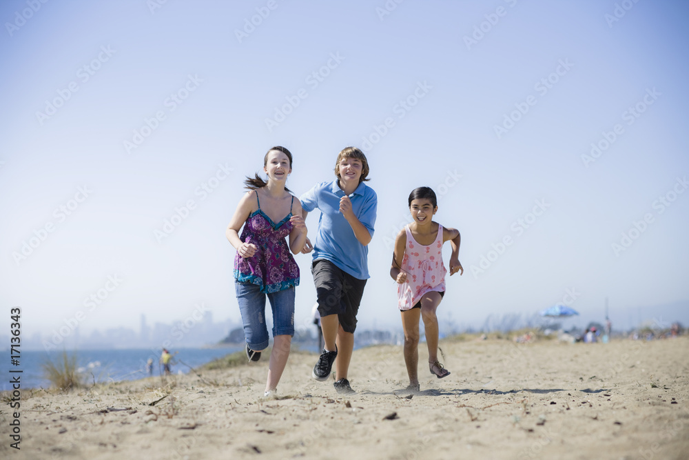 Three Kids Running on Beach Three Kids Running on Beach