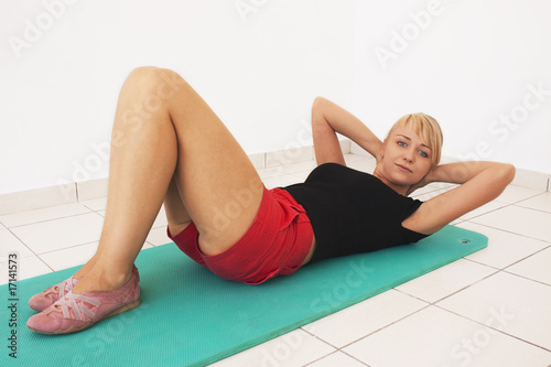 Young blond woman workout in gym