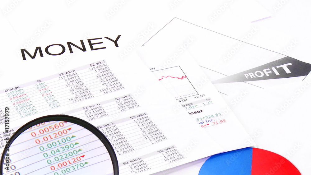 Close-up of a magnifying glass showing business profits Close-up of a magnifying glass showing business profits