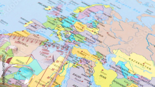 High view of a compass and world map turning