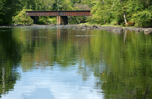 Peaceful river with railroad bridge