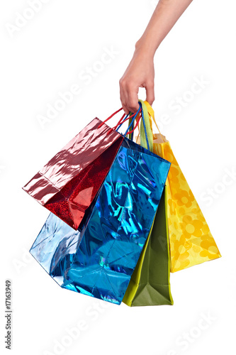 female hand holding colored bags