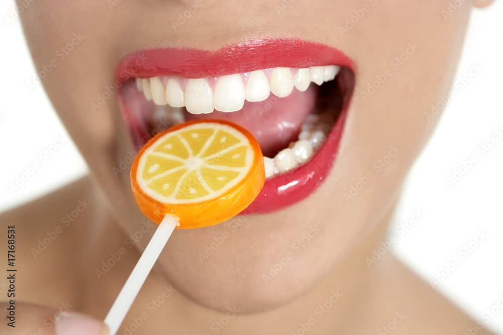 Naklejka premium Colorful Lollypop in perfect woman teeth