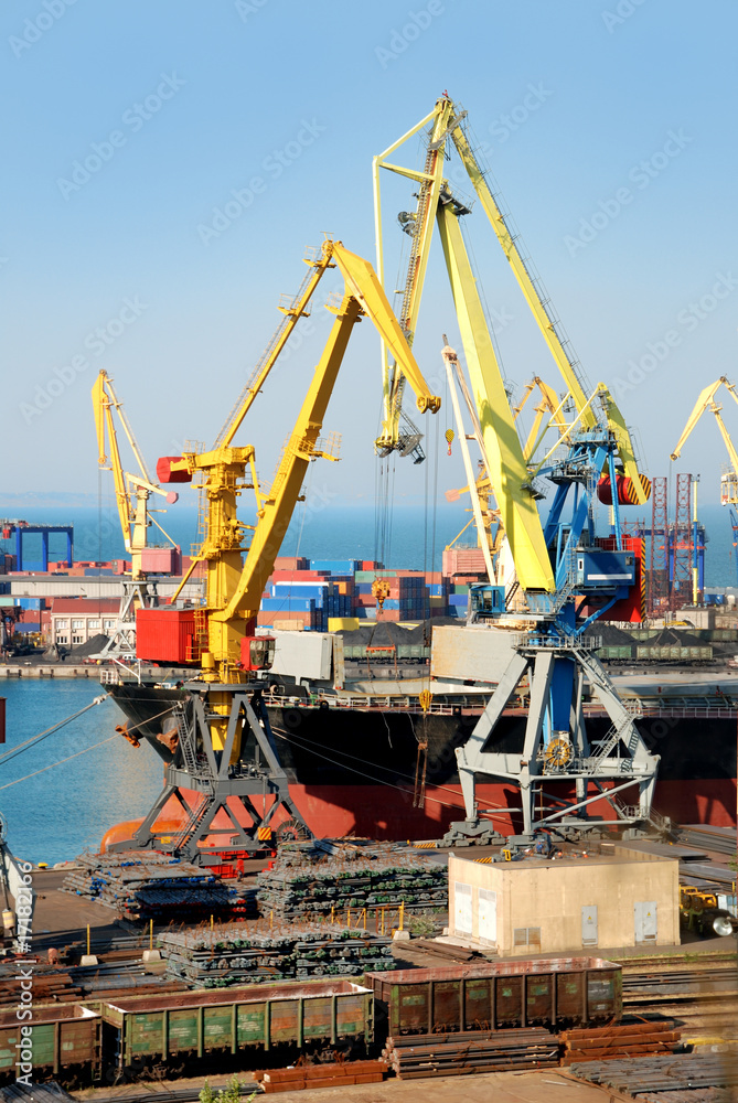The trading seaport with cranes, cargoes and ship