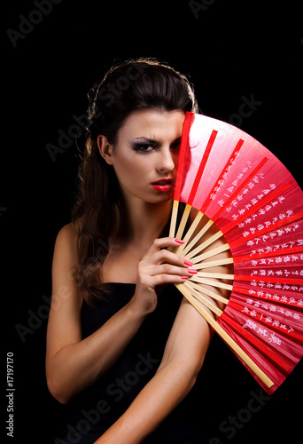 Beautiful woman with red fan