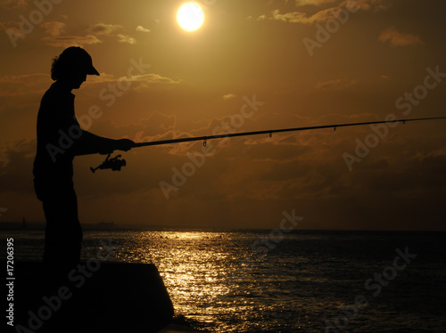 Fisherman silhouette at sunset