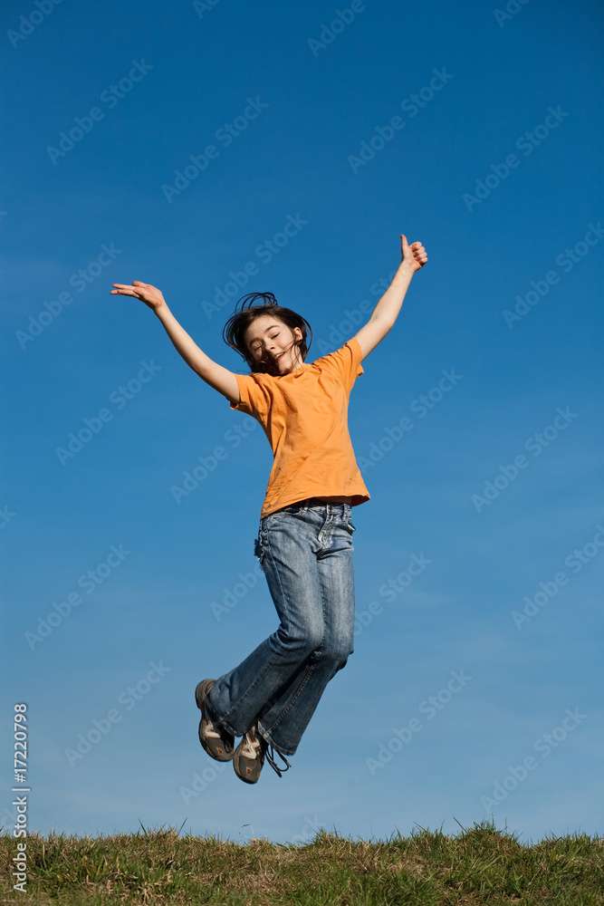 Girl jumping, running against blue sky Girl jumping, running against blue sky