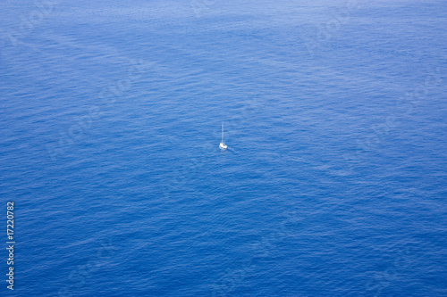 Single boat sailing in a vast ocean © barneyboogles