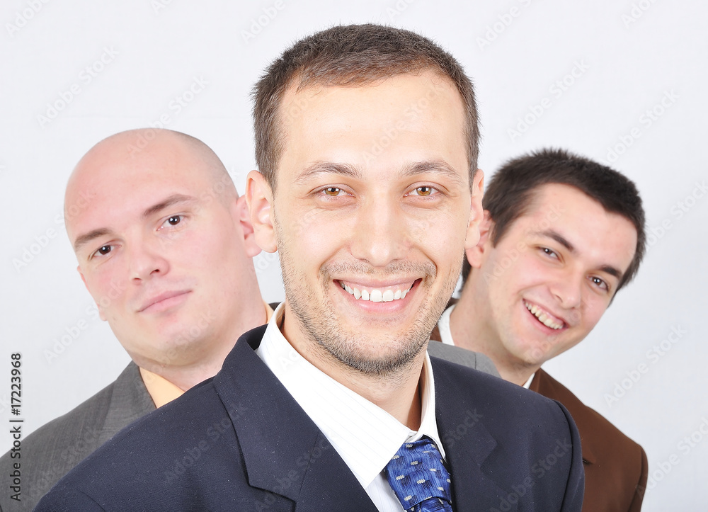 Group of young businessmen together on light background Group of young businessmen together on light background