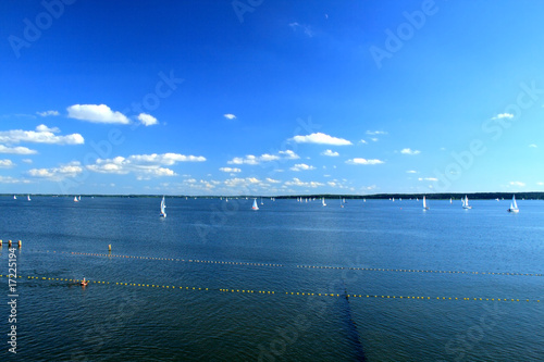 Yachts sailing on the lake under colorful sky