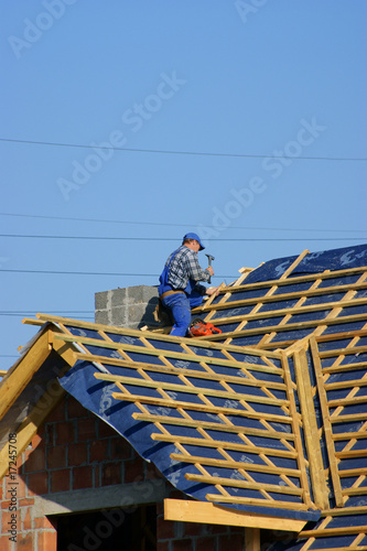 Man building construction roof