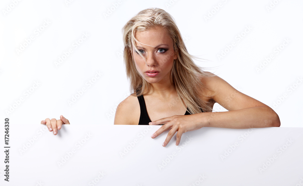 Beautiful blonde girl showing empty white board Beautiful blonde girl showing empty white board
