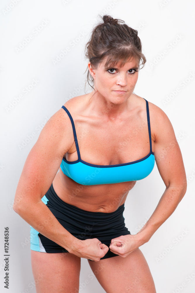 Mature female athlete flexing her muscles Mature female athlete flexing her muscles