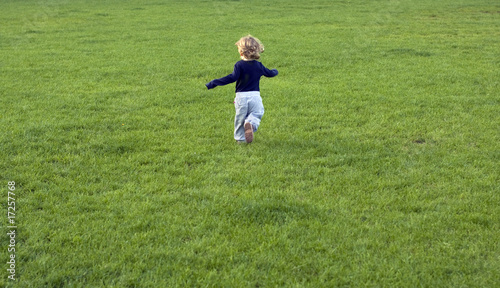kid running on the grass field