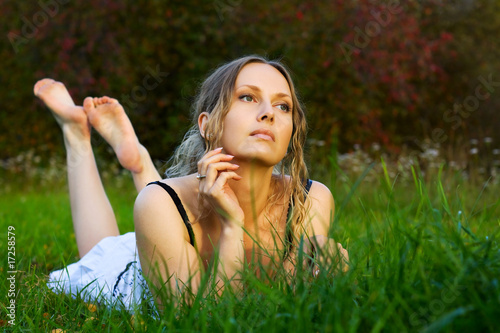 Beautiful young woman on the grass.