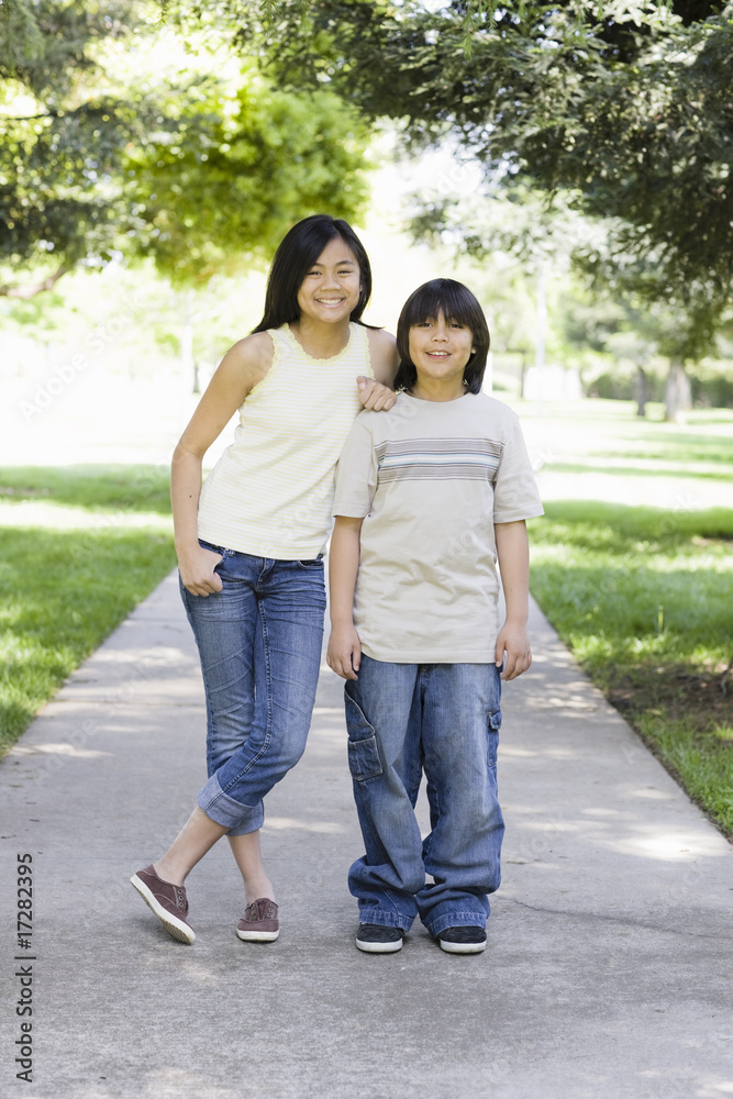 Asian Brother and Sister Smiling To Camera