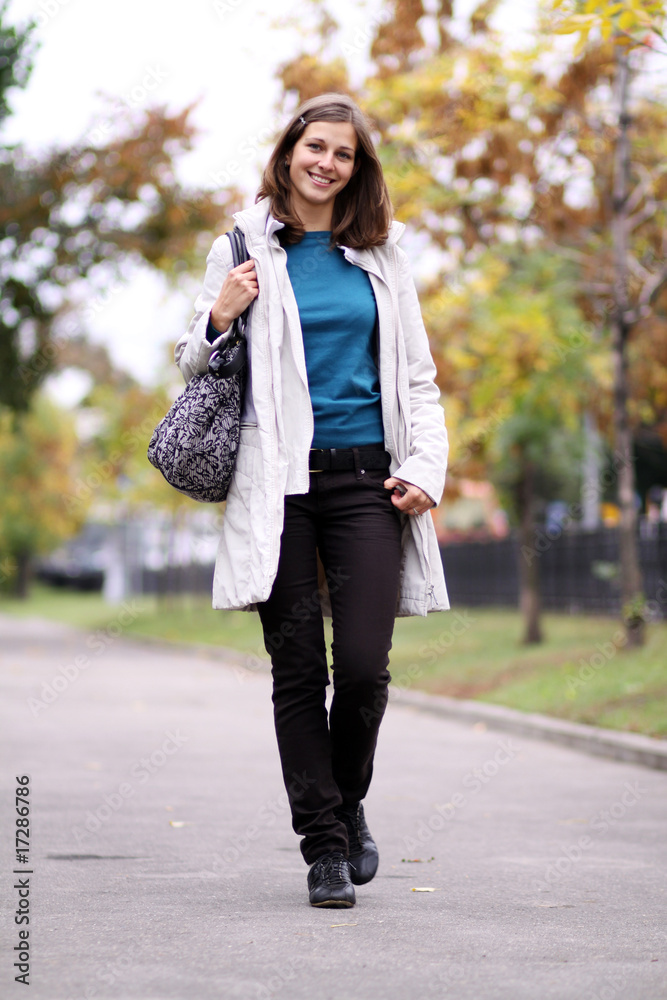 Fototapeta premium Beautiful young woman in autumn park