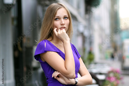 Portrait of a young woman smiling on urban background