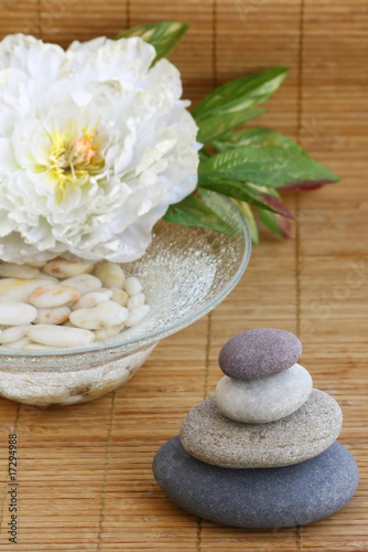 pebbles  flower and bowl with water and white pebbles