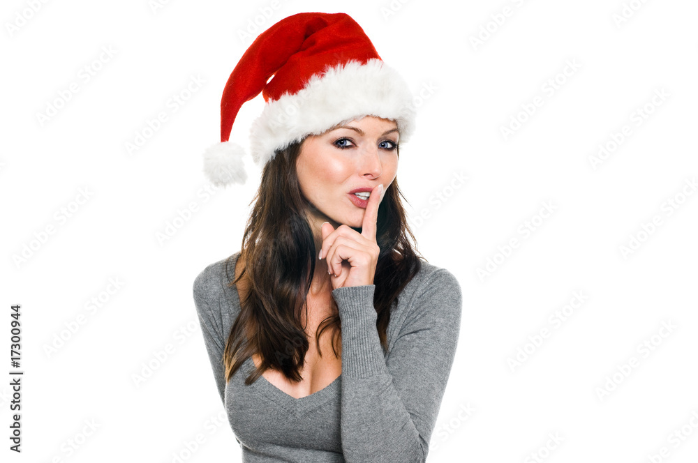 Frau mit Weihnachtsmütze hält Finger vor dem Mund Frau mit Weihnachtsmütze hält Finger vor dem Mund