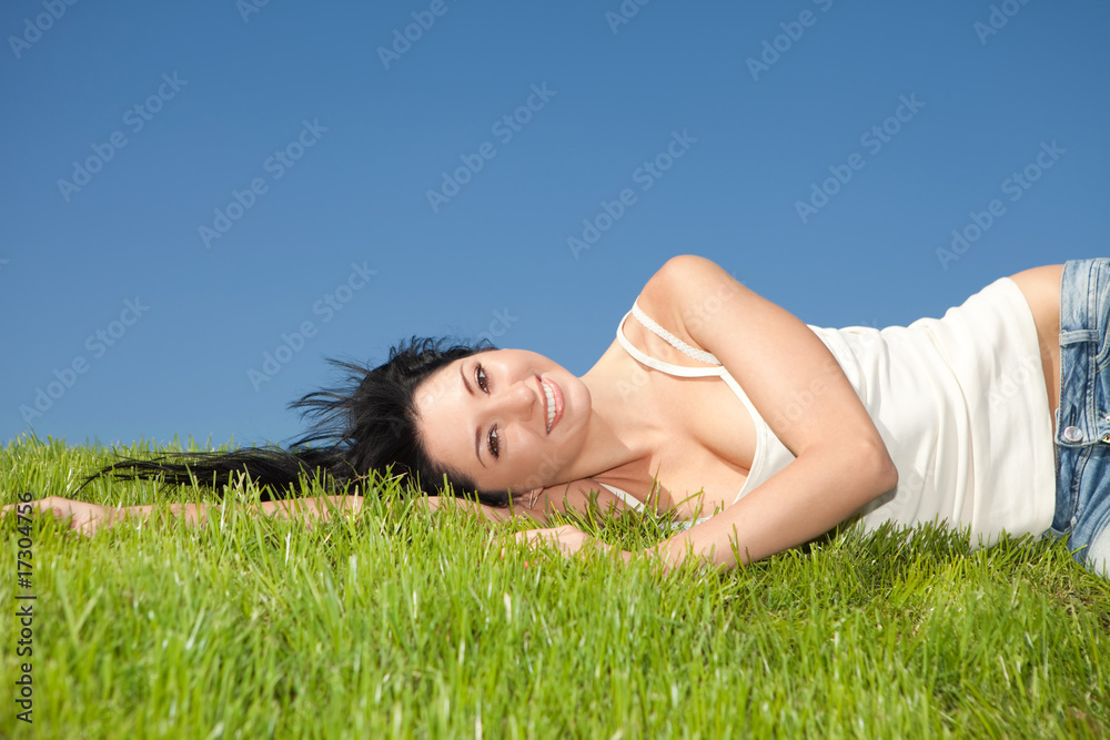 happy young woman rest on the green grass happy young woman rest on the green grass