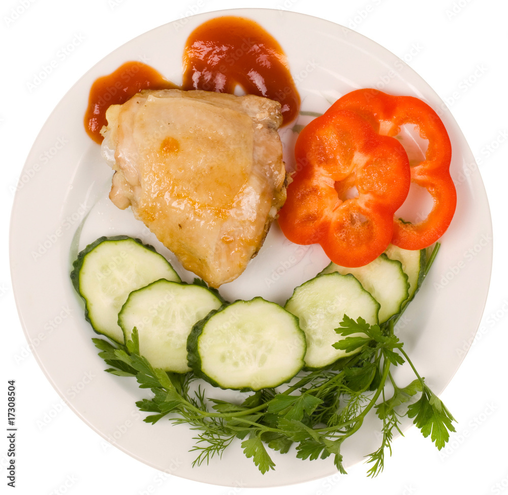 Part of the fried chicken with green-stuffs on a white dish Part of the fried chicken with green-stuffs on a white dish