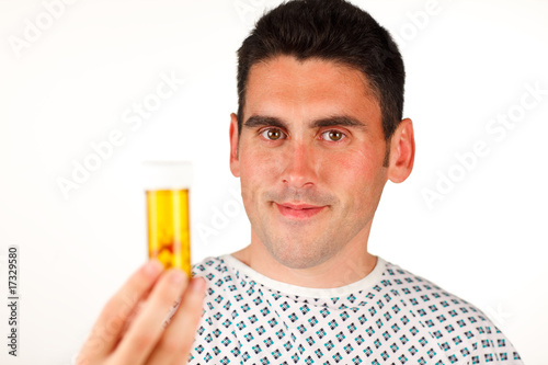 Patient holding pills and smiling
