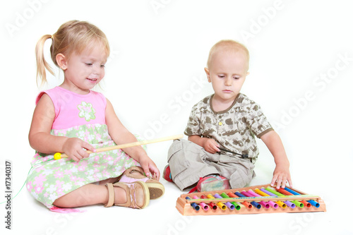 two children playing music piano over white