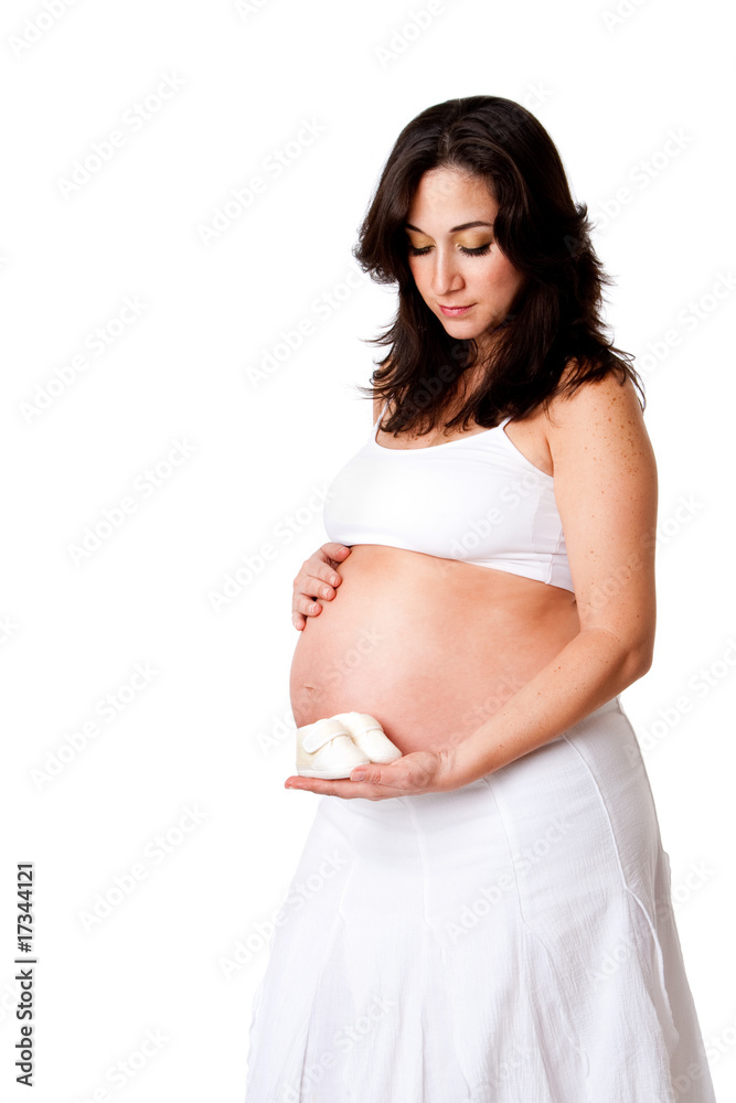 Pregnant woman holding baby shoes Pregnant woman holding baby shoes
