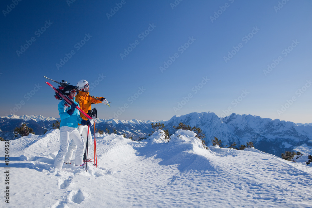 couple with ski equipment on mountain
