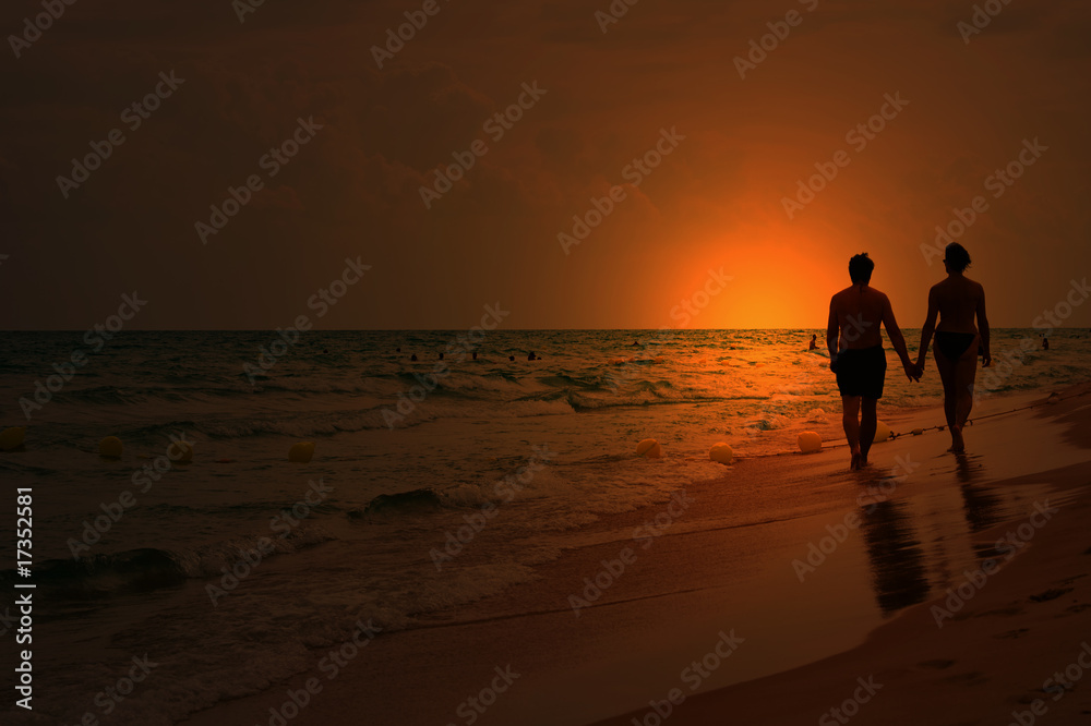 love couple walking on the beach at sunset